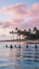 Group of surfers waiting for waves during sunset