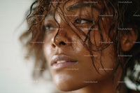 Close-up Portrait of a Woman with Curly Wet Hair and Natural Glow