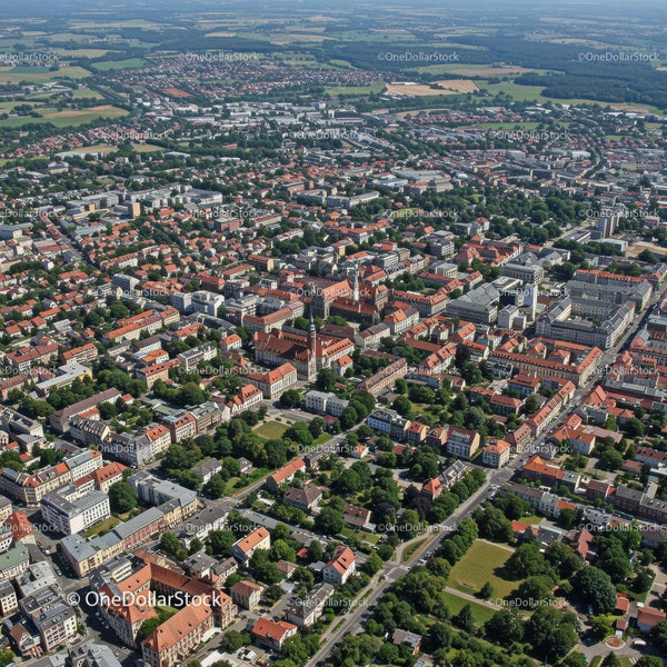 Aerial View of a Vibrant City with Red Roofs and Green Parks