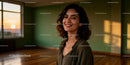 Smiling young woman enjoying sunset in spacious room