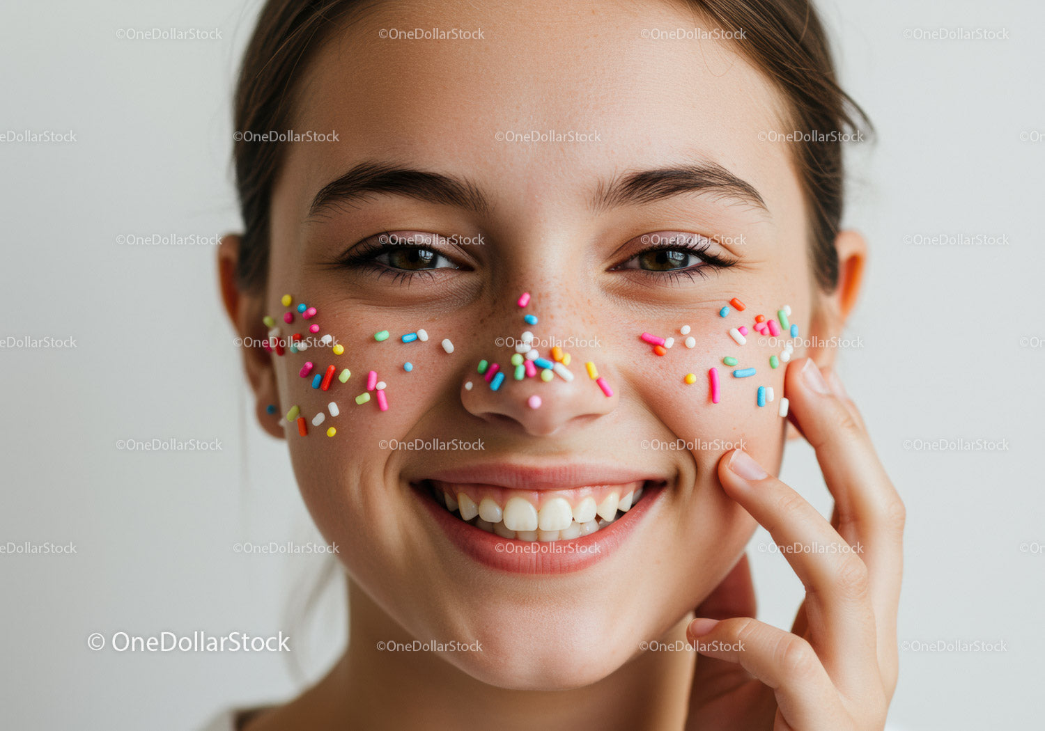 Young Woman Smiling with Colorful Sprinkles on Her Face in Bright Portrait