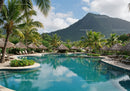 Tropical Resort with Swimming Pool Surrounded by Palms and Mountain View