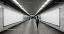 Modern Subway Passage with Pedestrians and Empty Advertising Boards