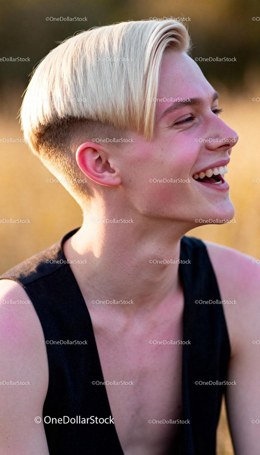Young person laughing outdoors in soft golden light