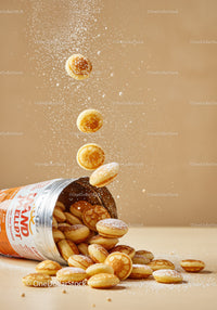 Mini Pancakes Sprinkled with Powdered Sugar in Motion