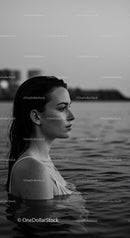 Serene Female Portrait in Water with Urban Background