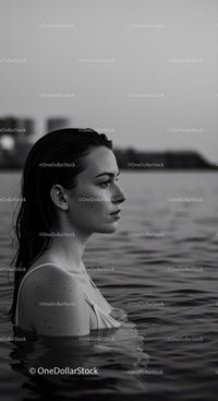 Serene Female Portrait in Water with Urban Background