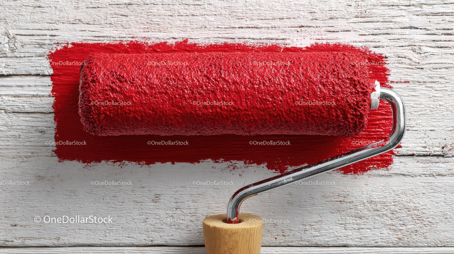Red Paint Roller on Rustic Wooden Surface for Home Renovation