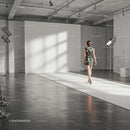 Fashion model walking runway in industrial photo studio