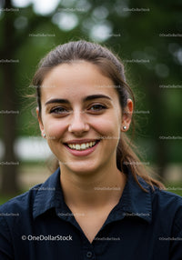 Young Woman Smiling Outdoors in Casual Attire with Bright Nature Background