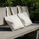 Blank Canvas Tote Bags Resting on Outdoor Stone Bench