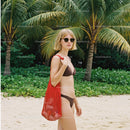 Woman in Bikini with Red Tote Bag on Tropical Beach with Palm Trees