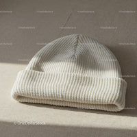 Soft White Knitted Beanie Hat on Neutral Fabric