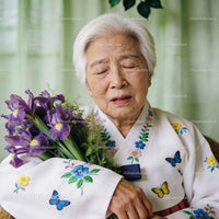 Elderly woman in traditional dress holding purple irises