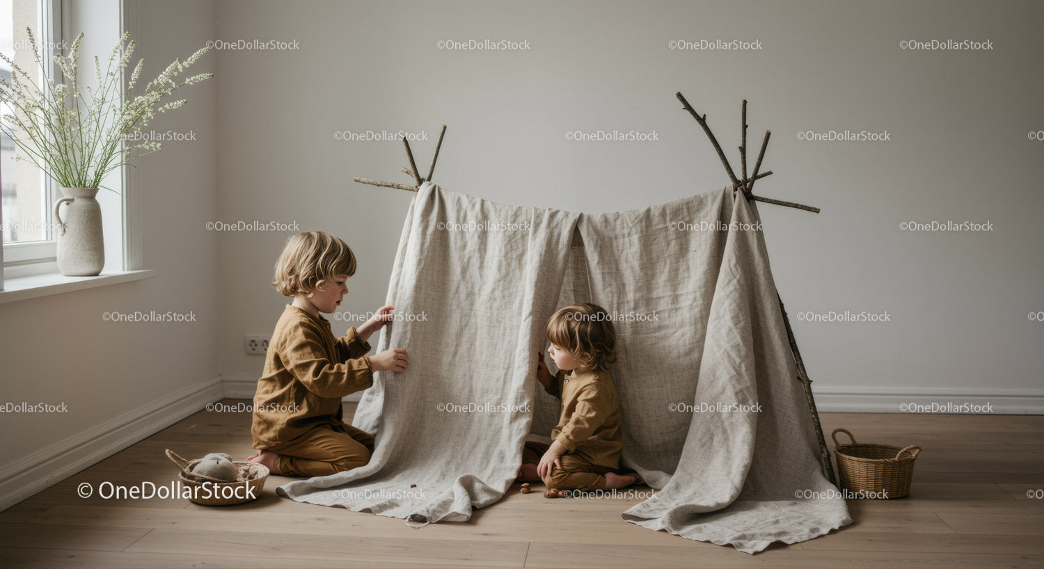 Two children playing in a handmade indoor tent