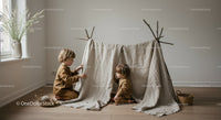 Two children playing in a handmade indoor tent