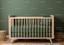 Stylish Wooden Baby Crib with Green Bedding in Modern Nursery