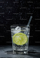 Refreshing sparkling water with lime slice and ice cubes