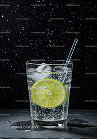 Refreshing sparkling water with lime slice and ice cubes