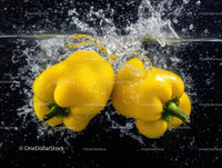 Yellow Bell Peppers Floating in Water with Splash Effect