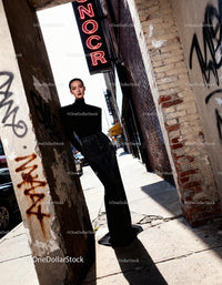 Elegant woman in black turtleneck on urban street