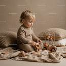 Toddler playing quietly with wooden toys indoors
