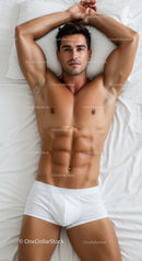 Fit young man relaxing on bed in white underwear
