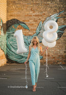 Young woman celebrating eighteenth birthday with balloons