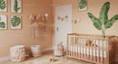 Sweet Baby Nursery with Wooden Crib and Green Plant Wall Art