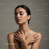 Serene young woman embracing herself with closed eyes