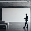 Businessman walking past empty modern gallery wall