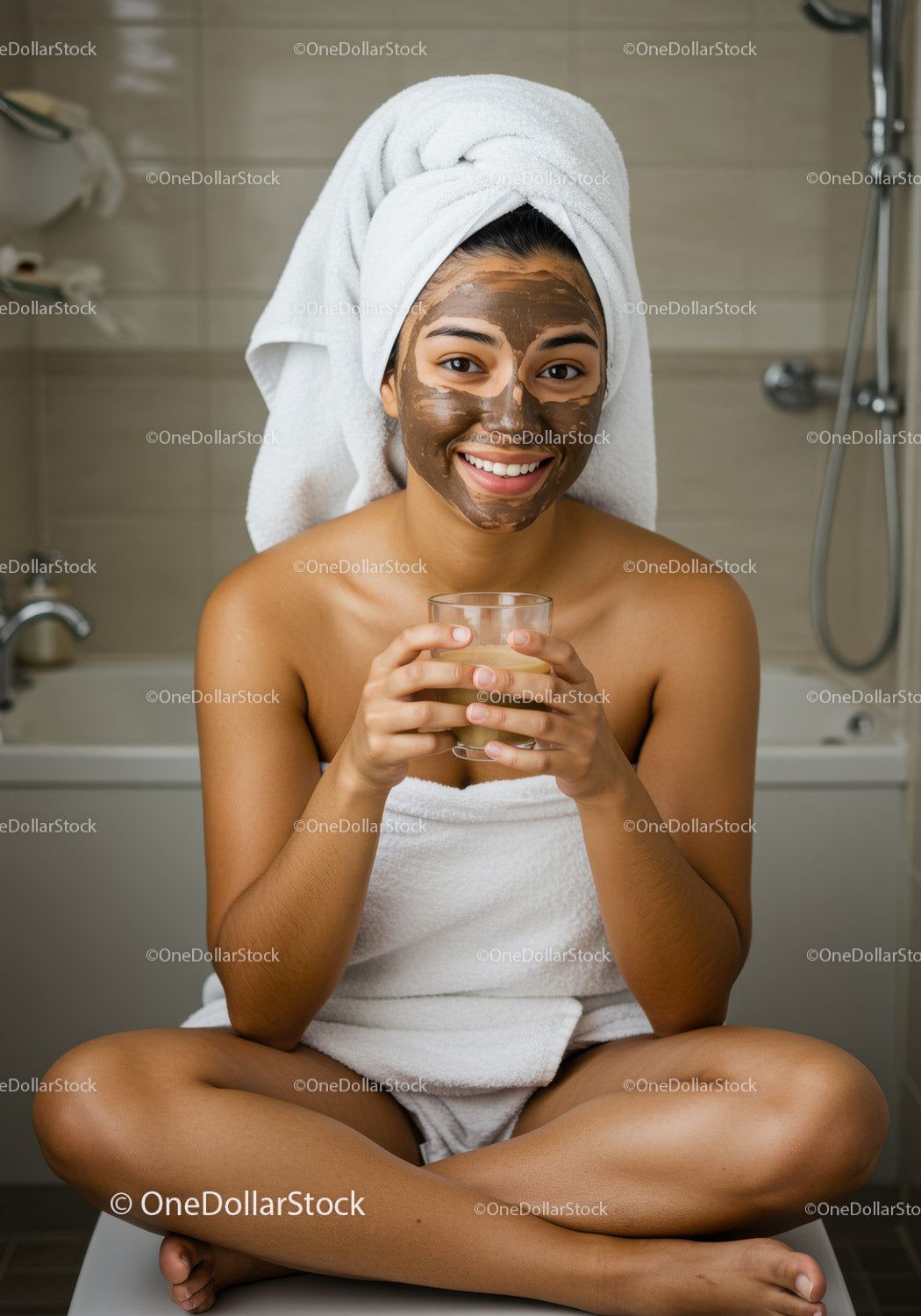 Young Woman with Facial Mud Mask Sitting Relaxed in Bathroom