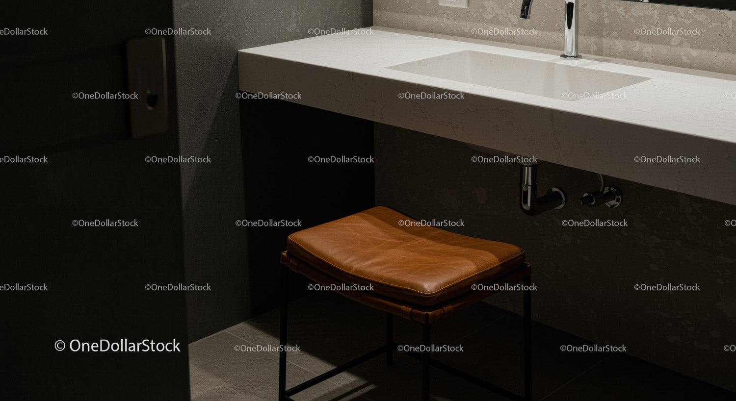 Elegant Modern Bathroom with Beige Stone Countertop and Leather Stool