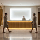 Guests Walking Past Minimalist Spa Reception Desk