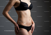 Elegant Woman in Black Lingerie with Body Tattoo Studio Portrait