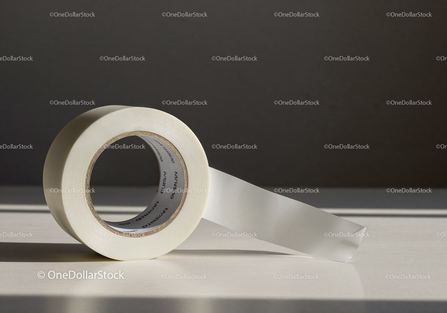 Roll of white adhesive tape on minimal background
