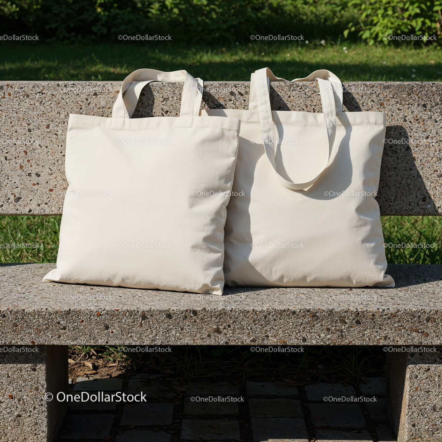 Two Blank Canvas Tote Bags on Outdoor Stone Bench