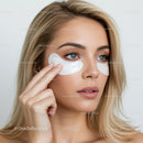 Woman with Blue Eyes Applying Under-Eye Patches for Inflammation Relief
