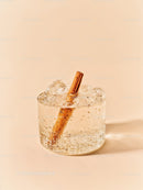 Refreshing Sparkling Drink with Cinnamon Stick on Beige