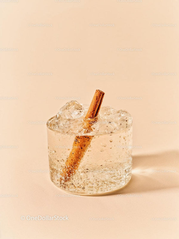 Refreshing Sparkling Drink with Cinnamon Stick on Beige