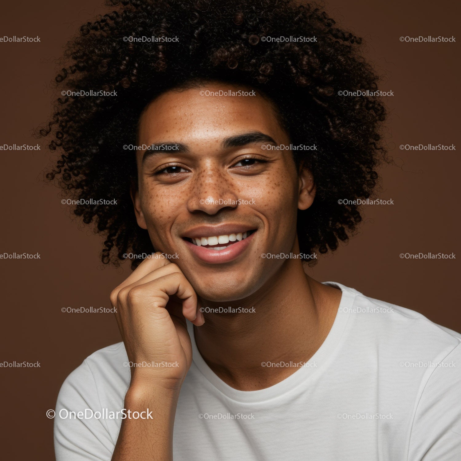 Portrait of a Smiling Young Man with Curly Hair and Freckles