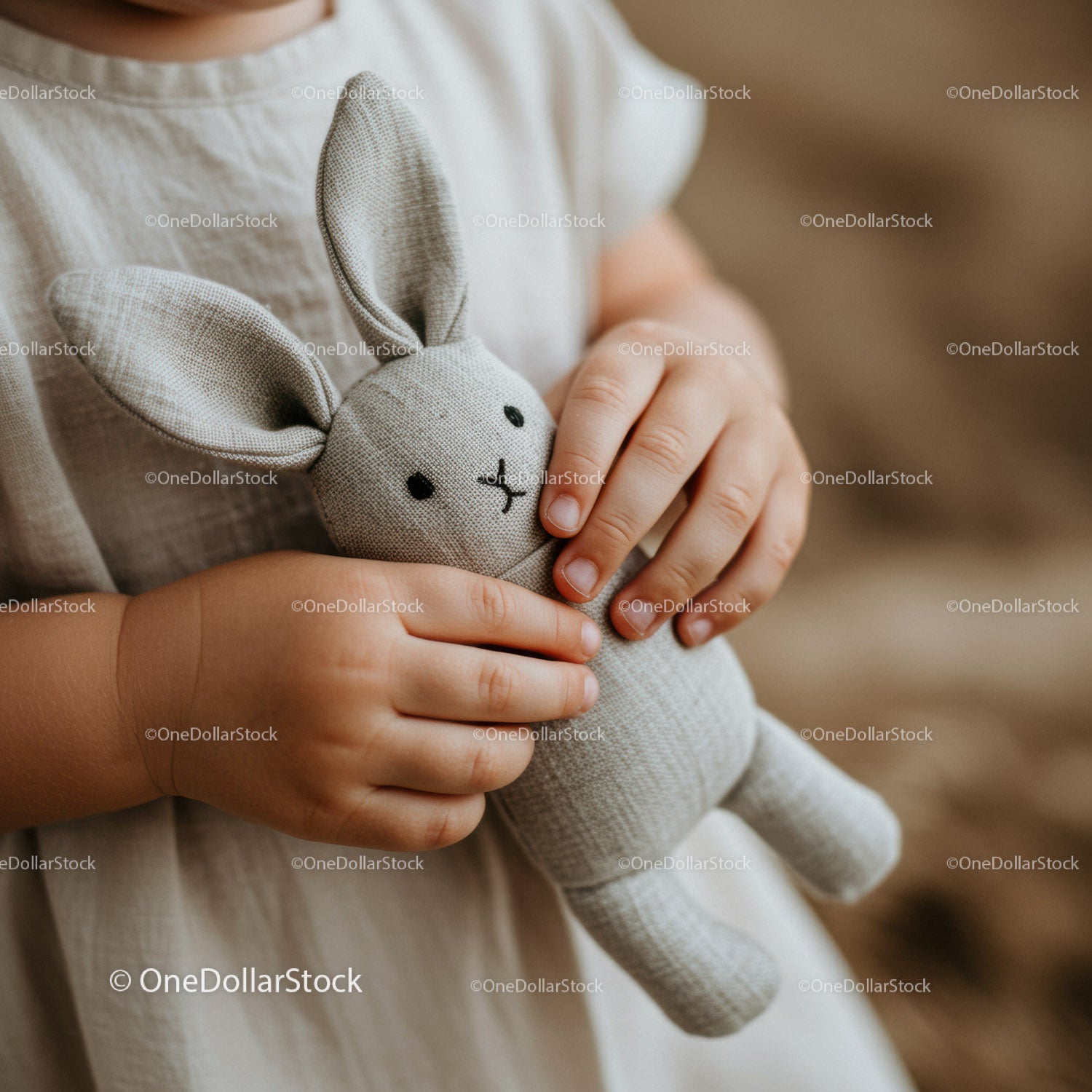 Child Holding Soft Fabric Bunny Toy Close Up