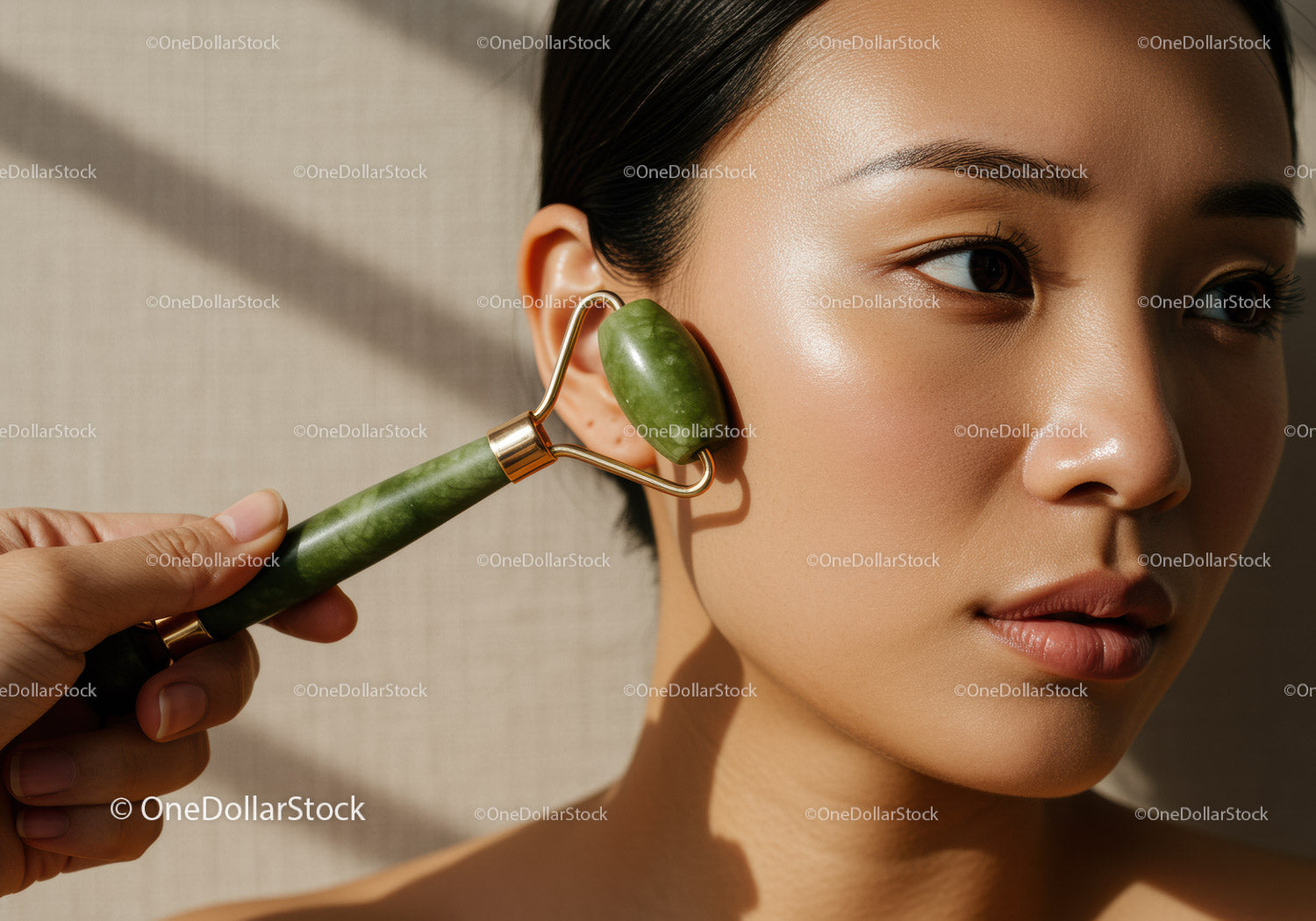 Close-up of a Woman Using Jade Roller for Facial Skin Care