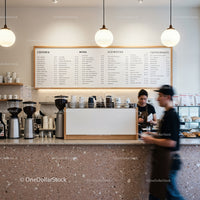 Modern cafe interior with baristas preparing orders