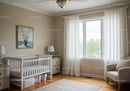 Bright Cozy Nursery with Baby Crib and Armchair in Natural Light