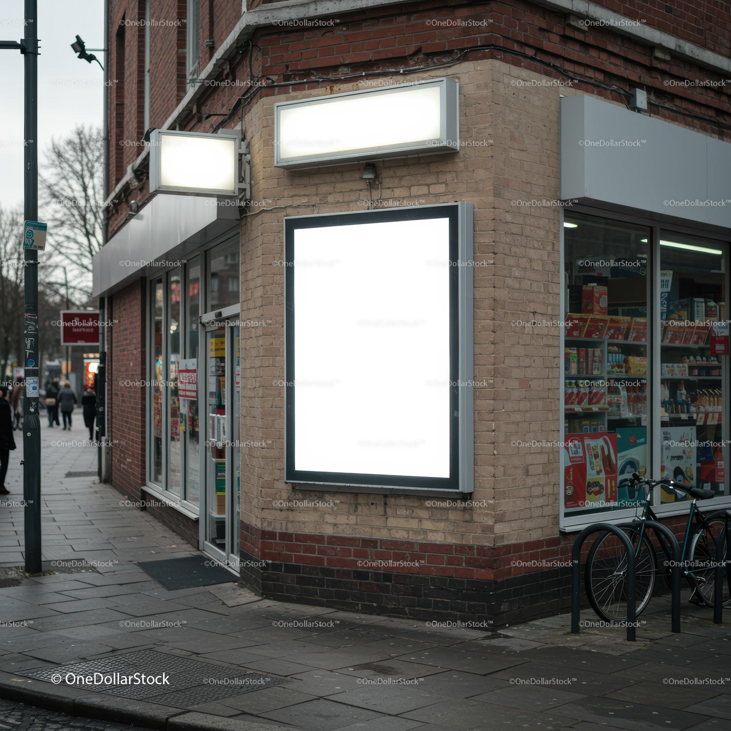 Empty illuminated billboard on urban corner store facade