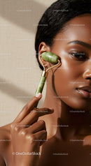 Close-up of a woman using a jade roller for facial massage