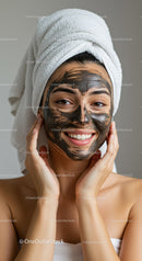 Woman with Black Facial Clay Mask and Towel Wrapped Hair