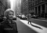 Elderly Woman in Stylish Coat Walking in Black and White Urban Scene