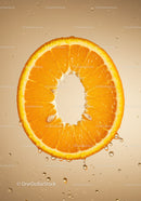 Fresh orange slice suspended in sparkling water droplets